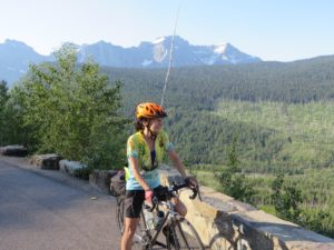 Julie Kumble admires a mountainous view during a cross-country bike trip.